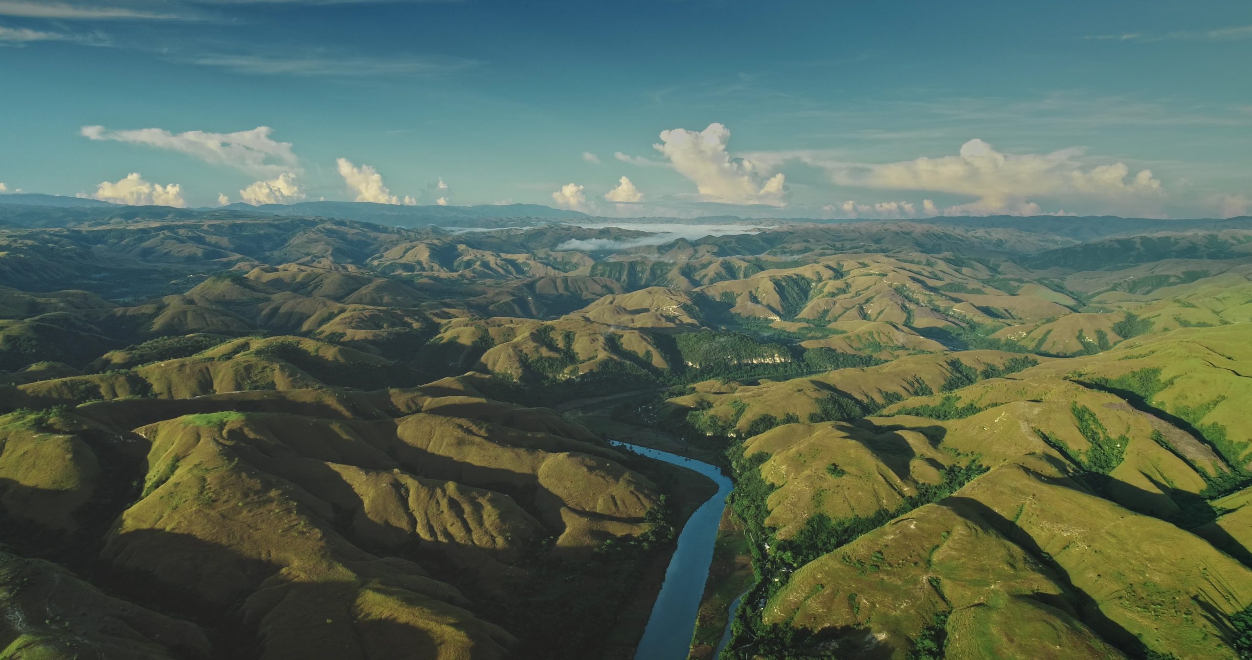Lush,Green,Hills,And,Valleys,Stretch,Endlessly.,With,A,Meandering