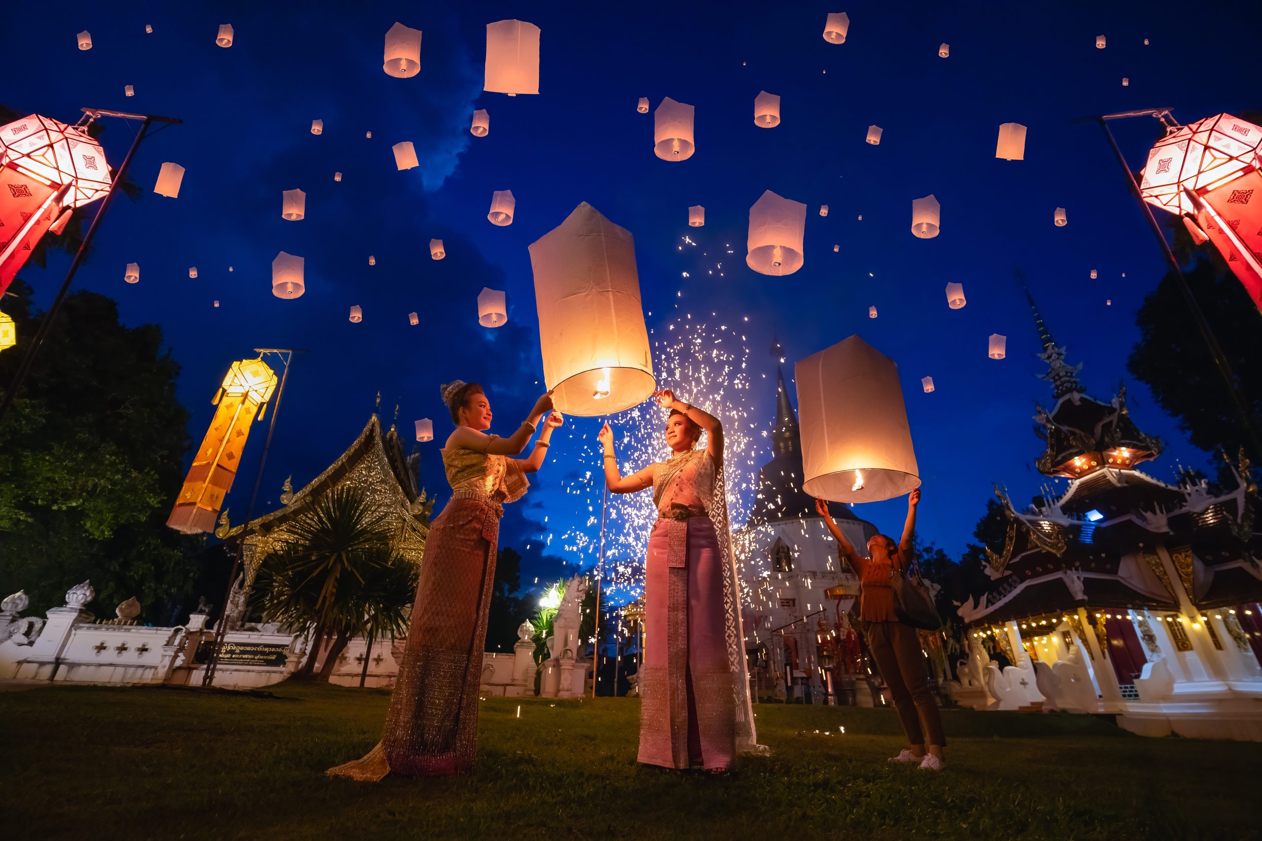 Young,Women,Releasing,Sky,Lantern,Into,The,Night,Sky,In