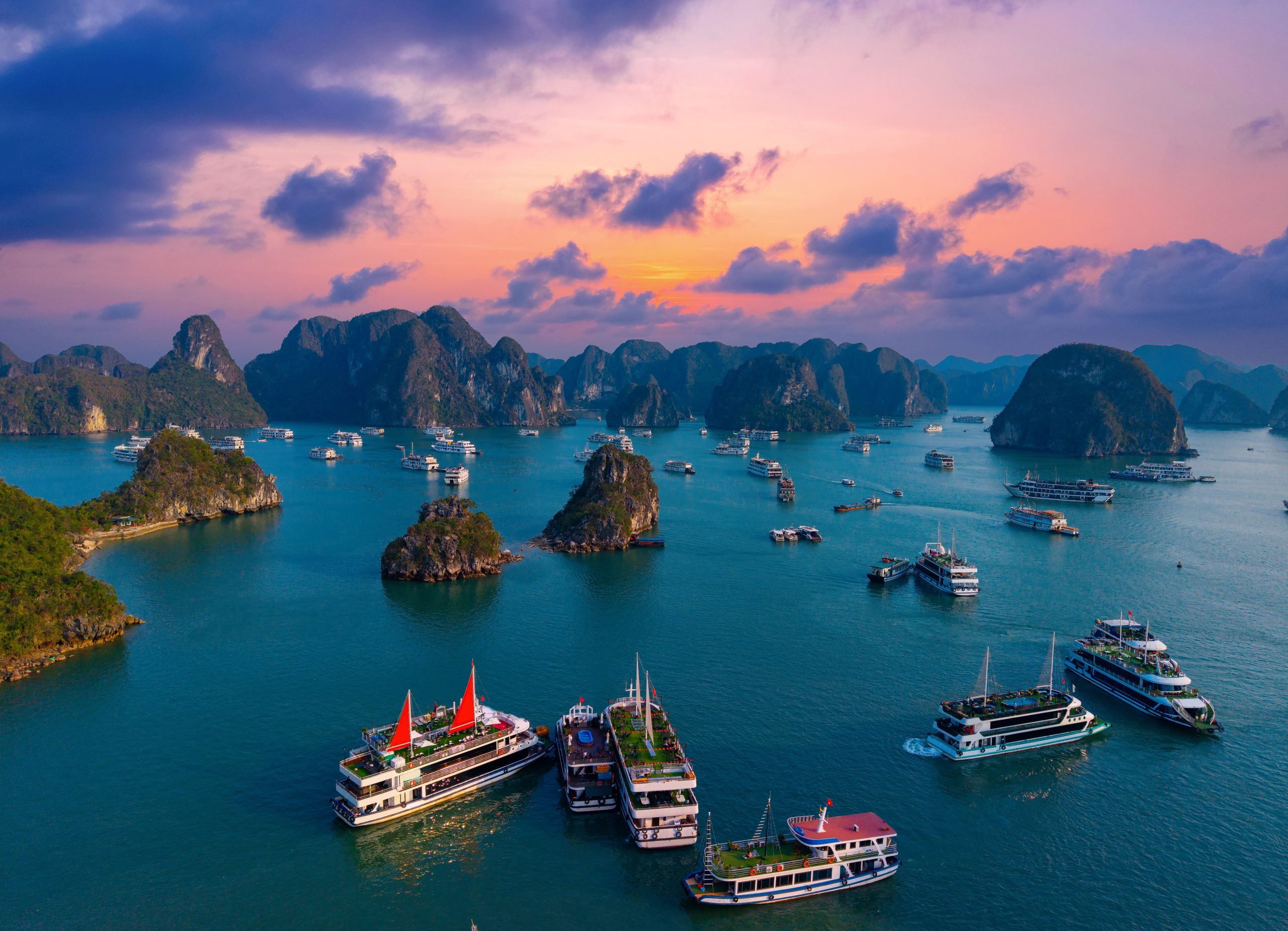 Aerial,View,Of,Sunset,Over,Halong,Bay,With,Tourist,Cruise