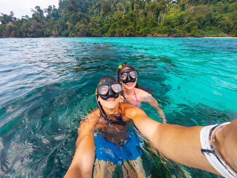 Two,Individuals,Enjoy,Snorkeling,In,Clear,Tropical,Waters,Surrounded,By