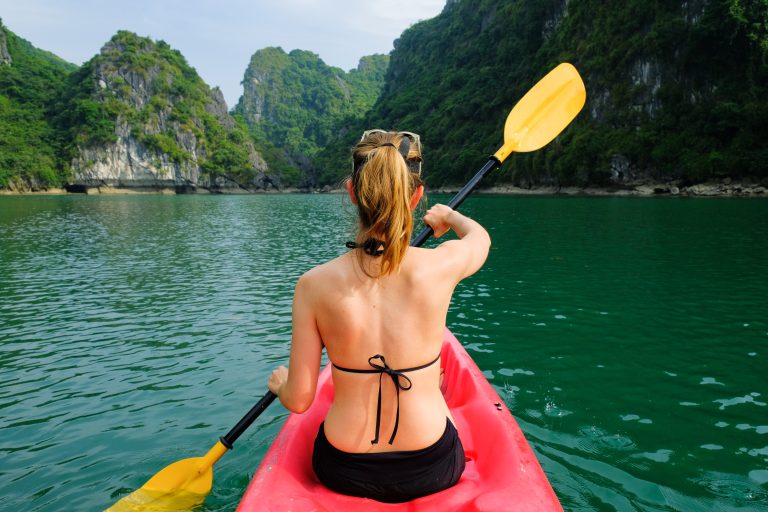 Woman,On,Kayak,Paddling,Through,Karst,Islands,And,Dense,Jungle