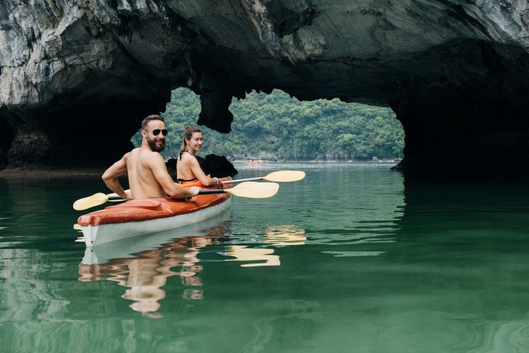 Couple,Paddle,On,Kayak,In,Halong,Bay.,View,From,The